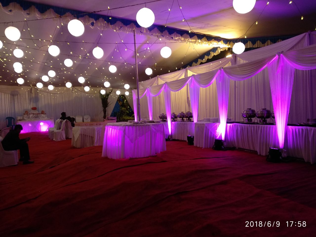 Lantern-lit banquet hall with purple uplighting